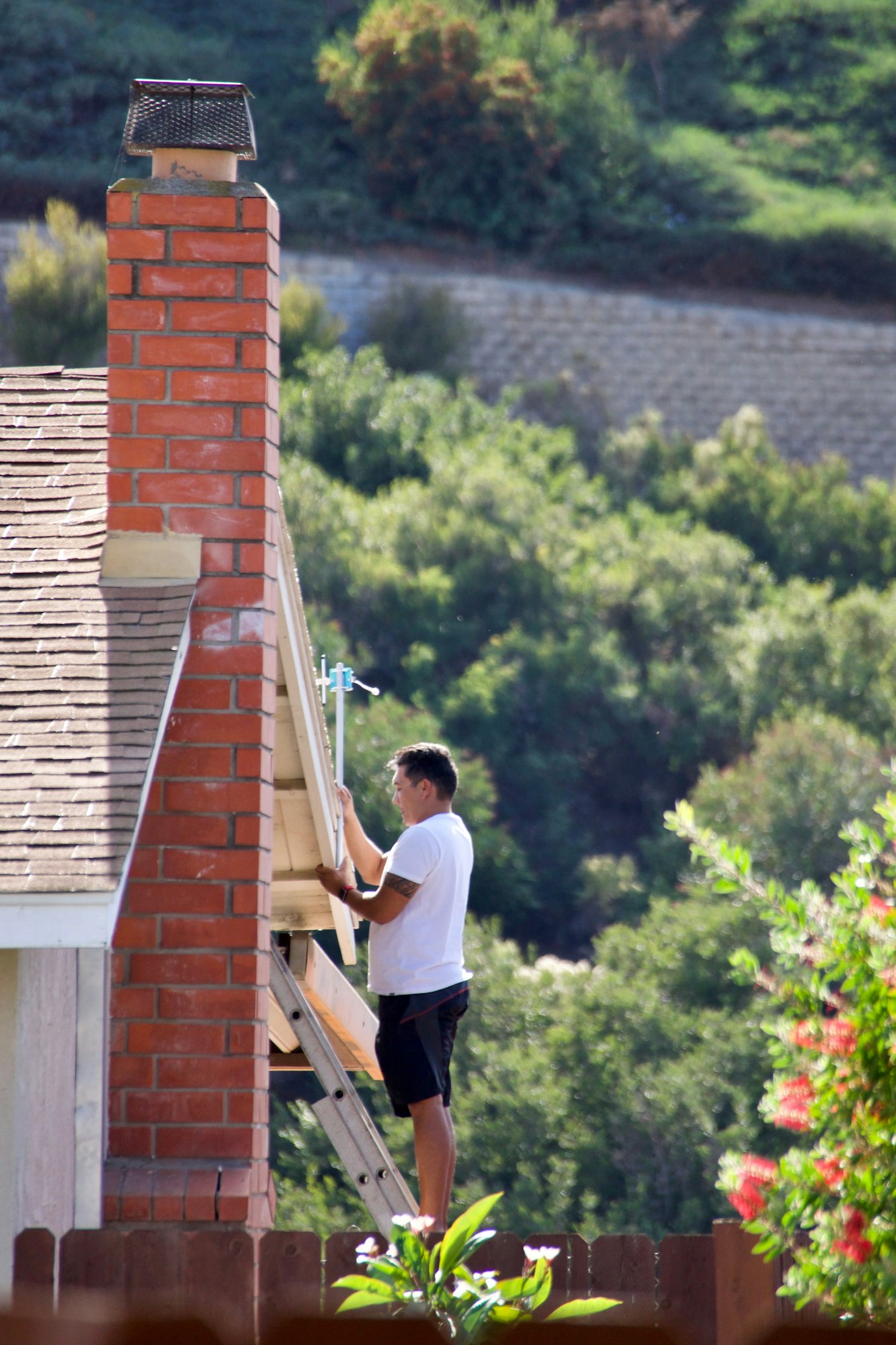 Man doing chores at home on a ladder